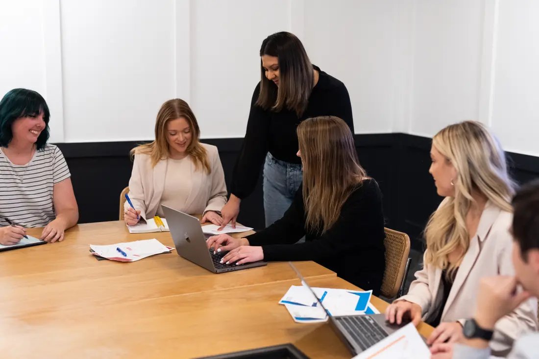 The Invoice Home Press and Marketing Team in action. Invoice Home Press Team and Marketing Team during an office meeting in a conference room.